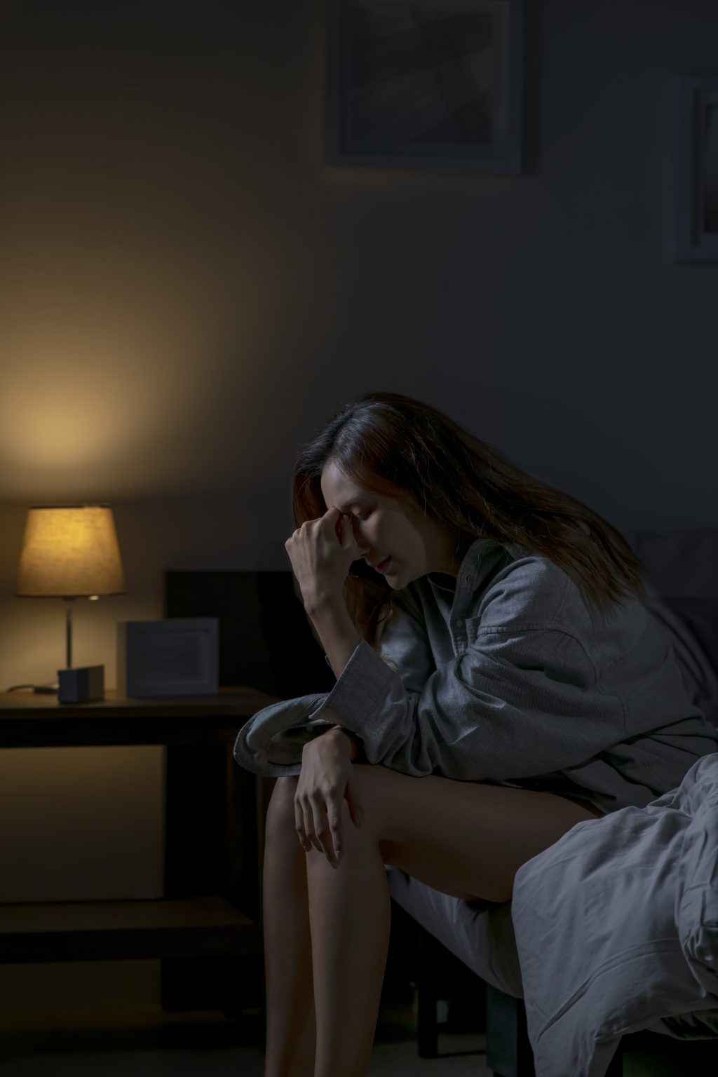 Woman struggling with sleeplessness at night during cognitive behavioral therapy for insomnia